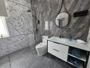 Modern bathroom with marble tiles and glass shower