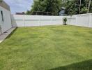 Well-maintained backyard with green grass
