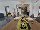 Modern dining room with elegant table setting leading to an open kitchen