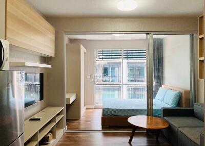 Living room view leading into bedroom with modern decor