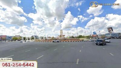 View of an open road with a roundabout and cloudy sky