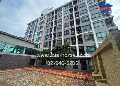 Exterior view of the multi-story residential building with pool and amenities