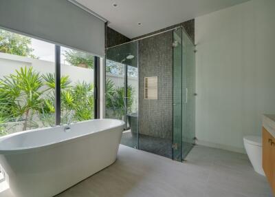 Modern bathroom with freestanding bathtub and glass-enclosed shower