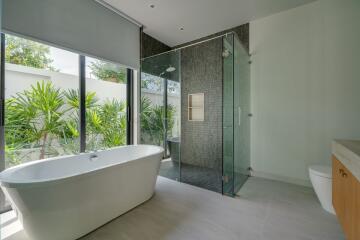 Modern bathroom with freestanding bathtub and glass-enclosed shower