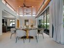 Modern dining room with wooden ceiling and large windows