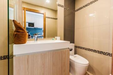 Modern bathroom with sink, mirror, and toilet