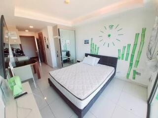 Modern bedroom with minimalistic design and green accents