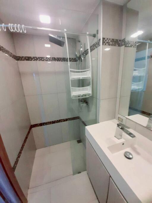 Modern bathroom with shower, sink, and mirror
