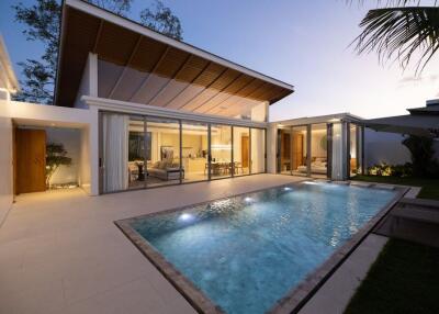 Modern house with illuminated swimming pool at dusk