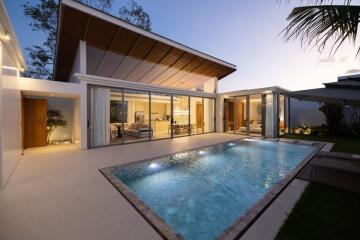 Modern house with illuminated swimming pool at dusk