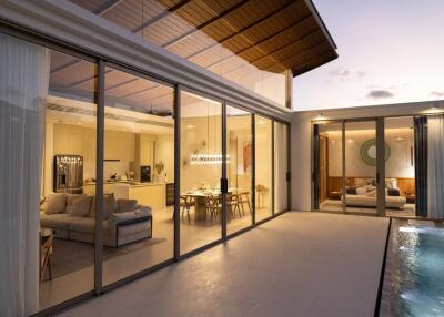 Modern house with glass sliding doors, evening lighting