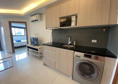 modern kitchen with integrated appliances and adjacent living area