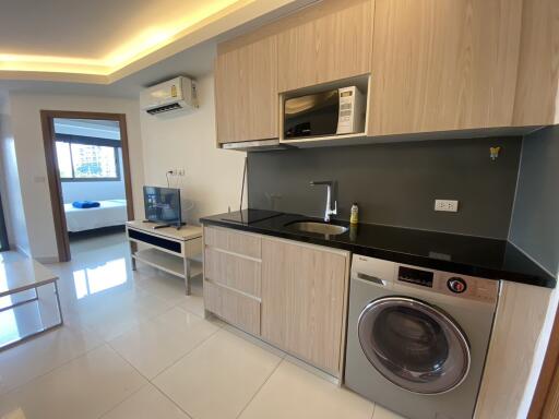 modern kitchen with integrated appliances and adjacent living area