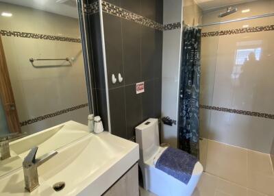 Modern bathroom with dual sinks and glass shower