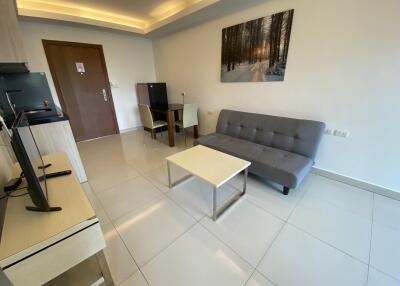 Bright modern living room with a couch, table and TV