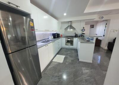 Modern kitchen with stainless steel appliances and white cabinets