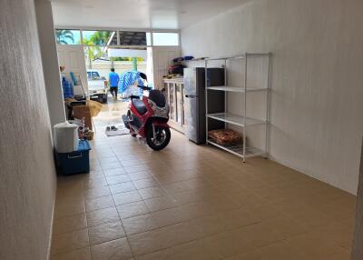 Spacious garage with a motorbike and shelving unit