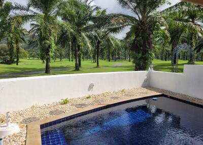 Private outdoor pool with view of palm trees and golf course