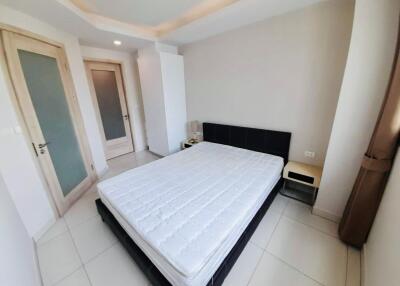 Spacious bedroom with bed and door to ensuite bathroom
