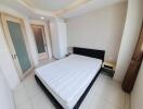 Spacious bedroom with bed and door to ensuite bathroom