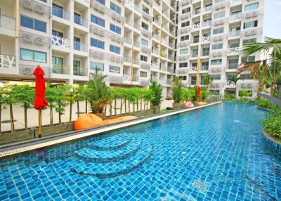 Outdoor pool area with apartment building