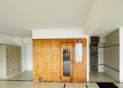 Entryway with wooden door and lockers