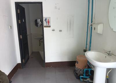 Image of a bathroom with a sink and access to a toilet