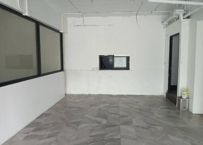 Empty office space with tiled floor and glass windows