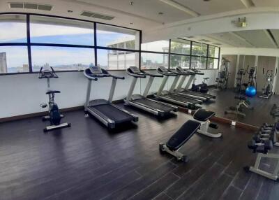 Spacious gym with modern equipment and large windows