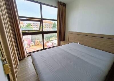 Bedroom with large window and modern furniture