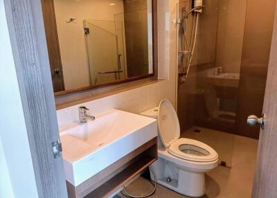 Modern bathroom with shower, sink, and toilet