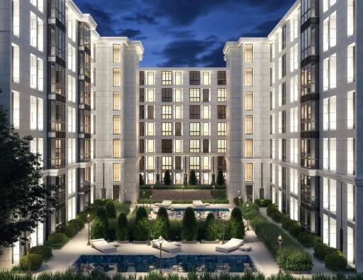 Luxury residential building exterior with landscaped courtyard at night
