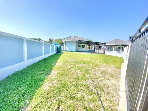 A single-story, modern contemporary-style single-family house at a good price, with garden space, located near a community hub.