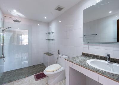 Modern bathroom with white tiles and walk-in shower