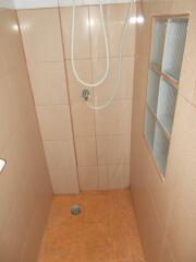 Simple tile shower area with frosted window