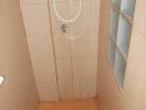 Simple tile shower area with frosted window