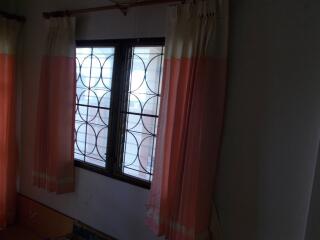 Bedroom with window and curtains