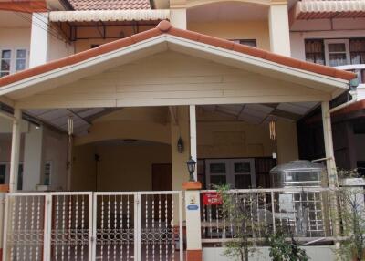 Front view of a townhouse with red roof tiles