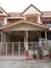 Front view of a townhouse with red roof tiles