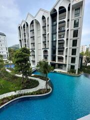 Modern apartment building with unique architectural design and outdoor pool