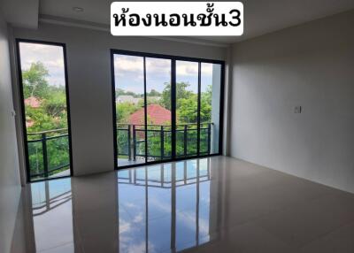 Empty bedroom with large windows and a view to the outside