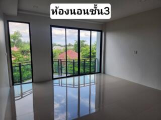 Empty bedroom with large windows and a view to the outside