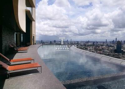 High-rise building with an infinity pool and city skyline view