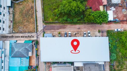 Aerial view of a building with a location marker