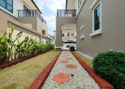 Pathway alongside a residential building with garden