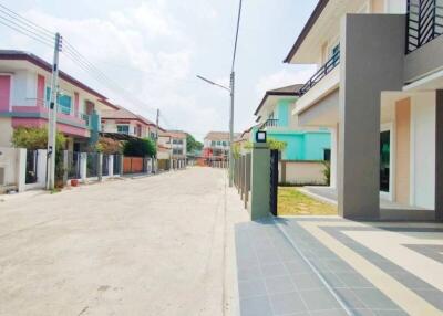 Street view of a residential neighborhood with multiple modern houses