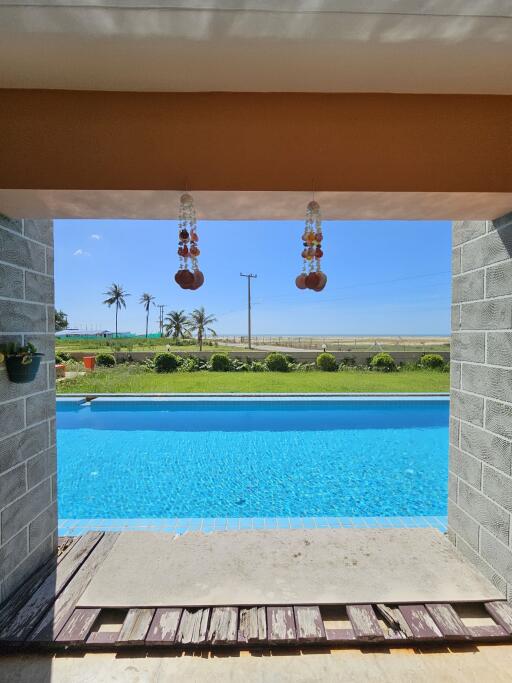 View of pool area with ocean in the background