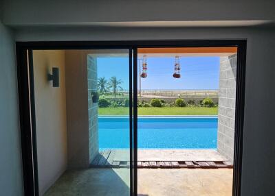 Sliding glass door leading to a pool and outdoor area