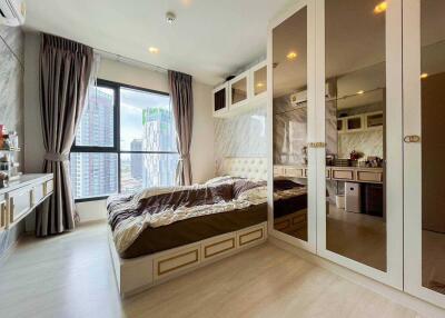 Contemporary bedroom with a large window and mirrored wardrobe