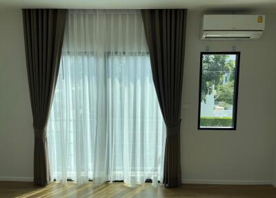 Living room with large window and curtains